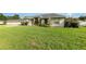 Beautiful single-story house with lush green lawn and a well-manicured garden in a quiet neighborhood at 629 Orange Valley Ln, Lakeland, FL 33813