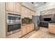 Modern kitchen with stainless steel appliances, wood cabinets, and granite countertops at 629 Orange Valley Ln, Lakeland, FL 33813