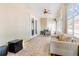 Sunroom with cream sofa, tiled floors, ceiling fan, and outdoor views at 629 Orange Valley Ln, Lakeland, FL 33813