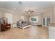 Spacious bedroom featuring a bed, vanity, ceiling fan, and shuttered windows at 629 Orange Valley Ln, Lakeland, FL 33813