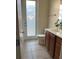 Bright bathroom featuring a vanity, toilet, and door providing natural light at 12064 Navale Ln, Orlando, FL 32827