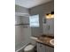 Clean bathroom featuring a shower-tub combo with subway tiles, a sink, and a window at 2123 Woodburn S Loop, Lakeland, FL 33813