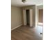 Cozy bedroom features wood-look floors, closet, and a window offering natural light at 2123 Woodburn S Loop, Lakeland, FL 33813