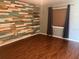 Bedroom featuring wood-look flooring, a decorative wood wall and a window with curtains at 2123 Woodburn S Loop, Lakeland, FL 33813