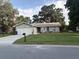 Charming single-story home with a well-maintained front yard, driveway, and attached garage at 2123 Woodburn S Loop, Lakeland, FL 33813
