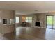 Spacious living room with wood-look flooring, stone fireplace, natural light and bar seating at 2123 Woodburn S Loop, Lakeland, FL 33813