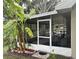 Screened-in patio offers outdoor living with a view, adjacent to lush, tropical landscaping at 2123 Woodburn S Loop, Lakeland, FL 33813