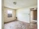 Bedroom featuring a side window and a doorway leading to an adjacent room at 303 Clayton Rd, Auburndale, FL 33823