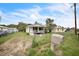 Modest home with front yard, chain link fence, and mailbox at 303 Clayton Rd, Auburndale, FL 33823