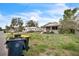 This property includes trash bins, a chain link fence and requires yard maintenance at 303 Clayton Rd, Auburndale, FL 33823
