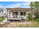Charming single-story home featuring a covered front porch and a low-maintenance yard at 303 Clayton Rd, Auburndale, FL 33823