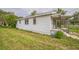 This home features white siding, a covered porch and sits on a large lot at 303 Clayton Rd, Auburndale, FL 33823