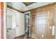 A short hallway leads to a small bathroom in need of repair at 303 Clayton Rd, Auburndale, FL 33823