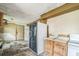 Dilapidated kitchen featuring dated appliances, cabinets, and worn flooring at 303 Clayton Rd, Auburndale, FL 33823