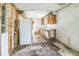 Outdated kitchen featuring worn appliances, aged cabinets, and damaged flooring at 303 Clayton Rd, Auburndale, FL 33823