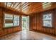 Inviting living room with wood paneled walls, natural light, and wood floors at 303 Clayton Rd, Auburndale, FL 33823