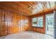 Cozy living room with wood paneled walls, wood floors, and natural light at 303 Clayton Rd, Auburndale, FL 33823