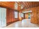 Bright living room featuring a neutral palette, wood paneled walls, and wood floors at 303 Clayton Rd, Auburndale, FL 33823