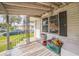 Covered front porch with seating, a view of the neighborhood, and access to the front door at 303 Clayton Rd, Auburndale, FL 33823