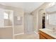 Bright bathroom featuring a vanity, shower with curtain, and tiled flooring creating a clean space at 3826 Sleepy Hill Oaks Loop, Lakeland, FL 33810