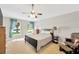 Cozy bedroom with a ceiling fan, carpet, two windows and a comfortable chair, creating a tranquil retreat at 3826 Sleepy Hill Oaks Loop, Lakeland, FL 33810