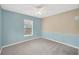 Bright bedroom featuring plush carpet, a ceiling fan, and a window for natural light at 3826 Sleepy Hill Oaks Loop, Lakeland, FL 33810