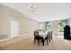 Inviting dining room with chandelier, bright windows, tile and carpet floors, perfect for Gathering gatherings at 3826 Sleepy Hill Oaks Loop, Lakeland, FL 33810