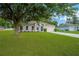 Charming single story home featuring a well maintained lawn and a blue front door at 3826 Sleepy Hill Oaks Loop, Lakeland, FL 33810