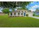 Well maintained single story home with a blue front door and landscaped front yard at 3826 Sleepy Hill Oaks Loop, Lakeland, FL 33810