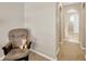 Hallway area with neutral color scheme, decorative arches, and comfortable chair, ready for relaxation at 3826 Sleepy Hill Oaks Loop, Lakeland, FL 33810