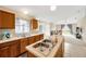 Modern kitchen with stainless steel sink and breakfast bar opening up into the living room at 3826 Sleepy Hill Oaks Loop, Lakeland, FL 33810