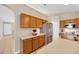 Bright kitchen with wood cabinetry, stainless steel refrigerator, and ample counter space at 3826 Sleepy Hill Oaks Loop, Lakeland, FL 33810