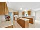 Bright kitchen with a large island, white countertops, oak cabinetry, and stainless steel appliances at 3826 Sleepy Hill Oaks Loop, Lakeland, FL 33810