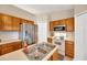 Functional kitchen featuring stainless steel appliances, double sink, and ample oak cabinetry for storage at 3826 Sleepy Hill Oaks Loop, Lakeland, FL 33810