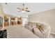 Open living space featuring carpet floors, a ceiling fan, and a comfortable sofa at 3826 Sleepy Hill Oaks Loop, Lakeland, FL 33810