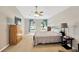 Bedroom with carpet, TV, two windows and neutral paint at 3826 Sleepy Hill Oaks Loop, Lakeland, FL 33810