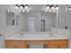 Bright bathroom with double sinks, vanity and large mirror with ample lighting at 3897 Beacon Ridge Way, Clermont, FL 34711