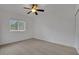 Neutral bedroom with a window and ceiling fan for comfortable living at 3897 Beacon Ridge Way, Clermont, FL 34711