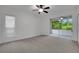 Bedroom with ceiling fan and sliding glass doors to a screened lanai at 3897 Beacon Ridge Way, Clermont, FL 34711