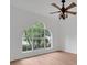 Bedroom featuring a large arched window and ceiling fan at 3897 Beacon Ridge Way, Clermont, FL 34711