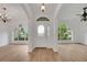 Bright entryway featuring wood floors and arched windows at 3897 Beacon Ridge Way, Clermont, FL 34711