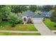 Inviting single-story home with lush landscaping and a two car garage at 3897 Beacon Ridge Way, Clermont, FL 34711