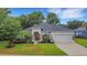 Charming single-story home with well-manicured lawn and mature landscaping at 3897 Beacon Ridge Way, Clermont, FL 34711