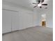 Spacious primary bedroom with ceiling fan, walk-in closets and access to bathroom at 3897 Beacon Ridge Way, Clermont, FL 34711