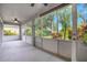 Spacious screened porch with ceiling fan and view of fenced backyard at 3897 Beacon Ridge Way, Clermont, FL 34711