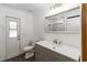 Bathroom featuring a single vanity sink, a large mirror, and neutral decor at 722 Swaying Palm Dr, Apopka, FL 32712