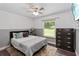 Comfortable bedroom with natural light, neutral tones, and hard wood floors at 722 Swaying Palm Dr, Apopka, FL 32712