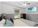 Bedroom featuring a window, ceiling fan, neutral decor and a wall-mounted television at 722 Swaying Palm Dr, Apopka, FL 32712