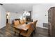 Bright dining room with modern chandelier and view of living room fireplace at 722 Swaying Palm Dr, Apopka, FL 32712