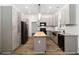 Modern kitchen featuring gray cabinets, butcher block island, and stainless steel appliances at 722 Swaying Palm Dr, Apopka, FL 32712